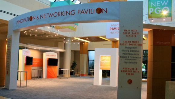 Trade show pavilion with custom signage and structures