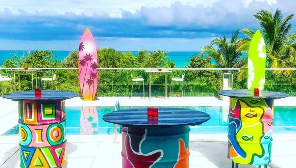 Colorful surf-themed decor setup by a scenic beachside pool