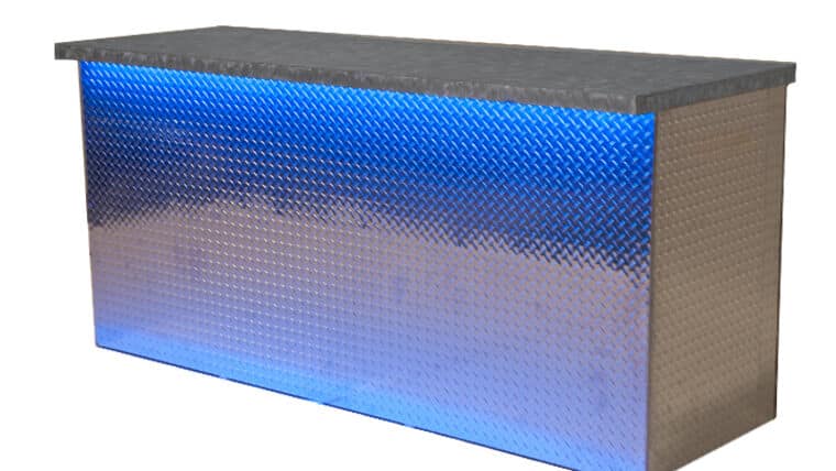 metallic Aluminum-Bar Table with a textured diamond pattern is illuminated by a vibrant blue light. The sleek, modern design conveys a stylish and futuristic tone.