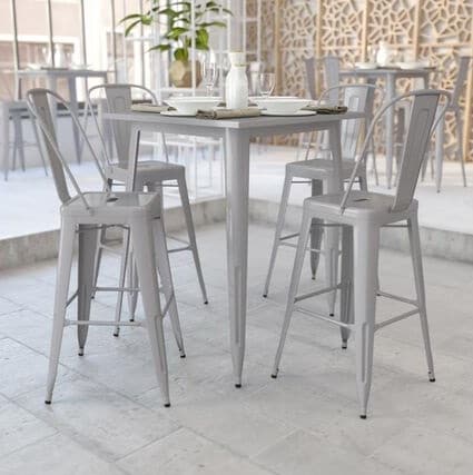 Cocktail Table Rentals outdoor dining setup with a square table and four tall gray chairs on a tiled patio.