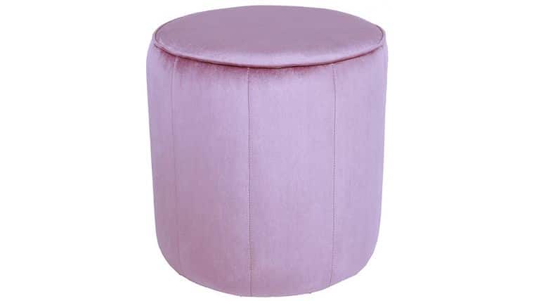 A round, light pink upholstered ottoman with a smooth, cushioned top and vertical stitching along the sides.