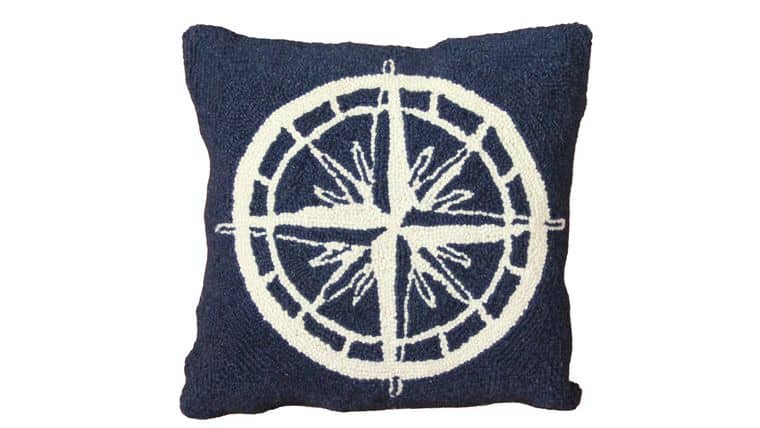 Square navy blue pillow featuring a large white compass design centered, evoking a nautical theme.