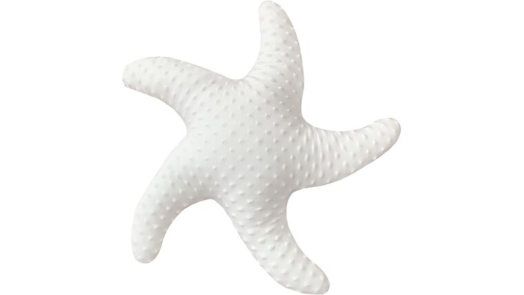 Pillow Statement starfish shaped cushion with a dotted pattern against a plain background.