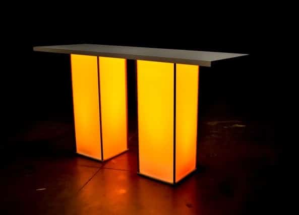 White Column LED Pub with a sleek white top and two illuminated orange rectangular pillars serving as legs, set against a dark background.
