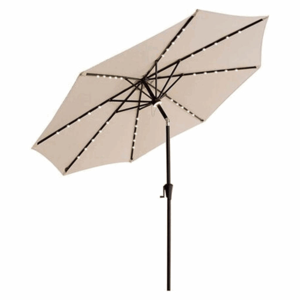 Tan patio Beige Umbrella with LED lights lining the ribs, attached to a black metal pole with a crank. The umbrella is open and tilted slightly to the side.