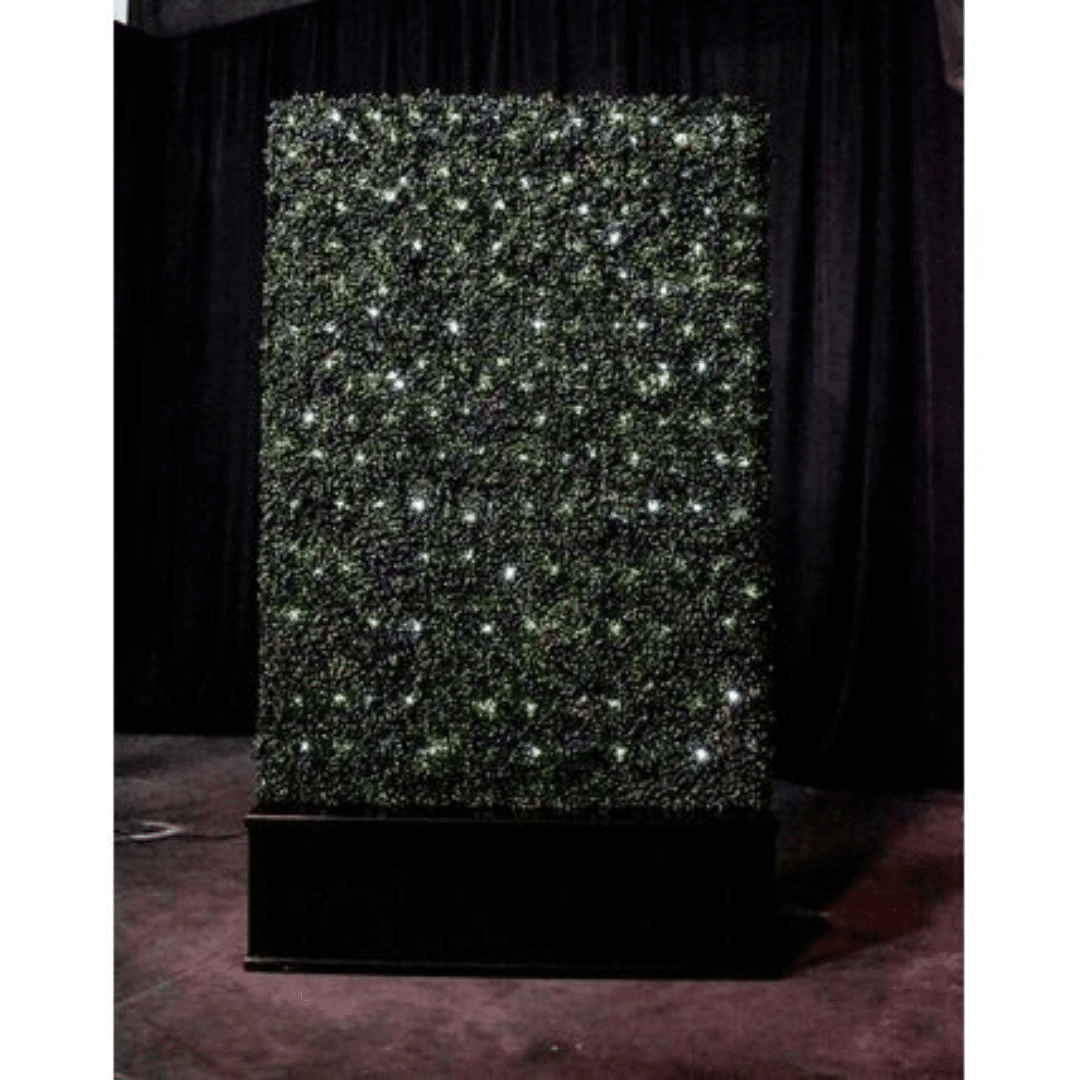 LED Black Base Hedge of twinkling green lights resembling stars on a black background, creating a mysterious and enchanting atmosphere.