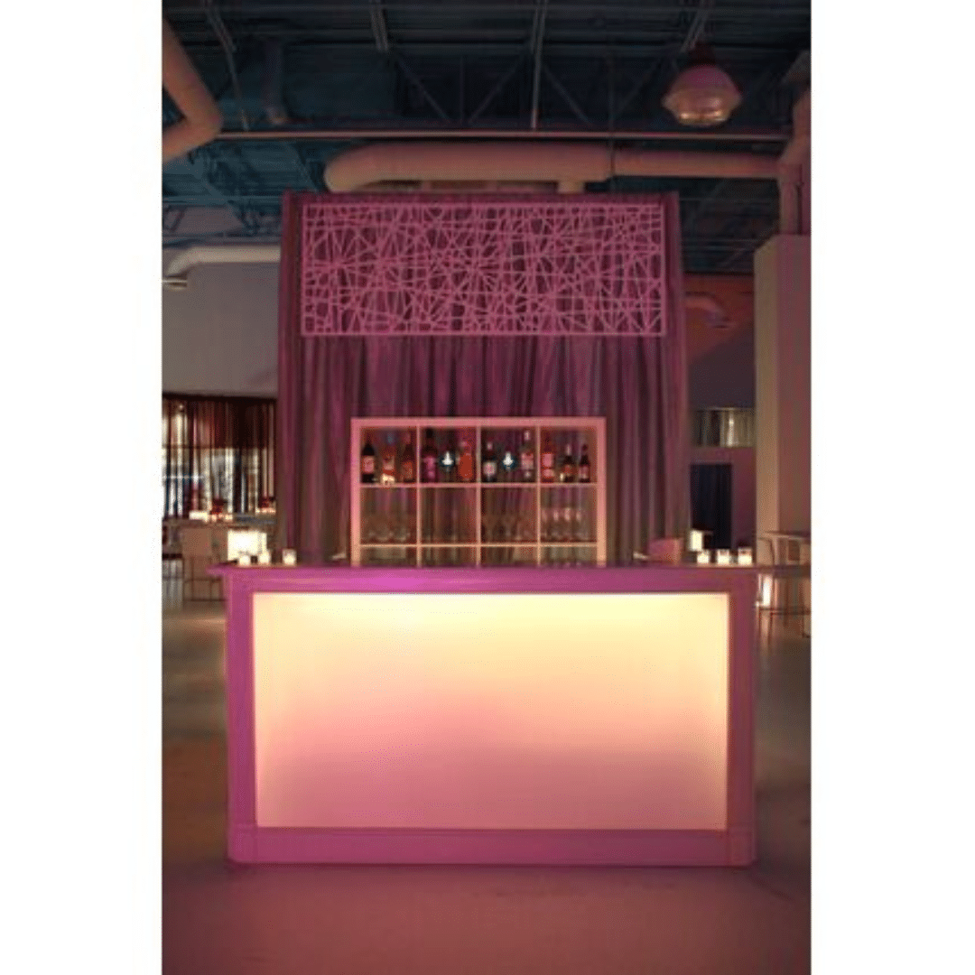 White Acrylic Bar - Short with soft pink lighting, featuring a geometric design backdrop. Bottles displayed on shelves, creating a chic and inviting ambiance.